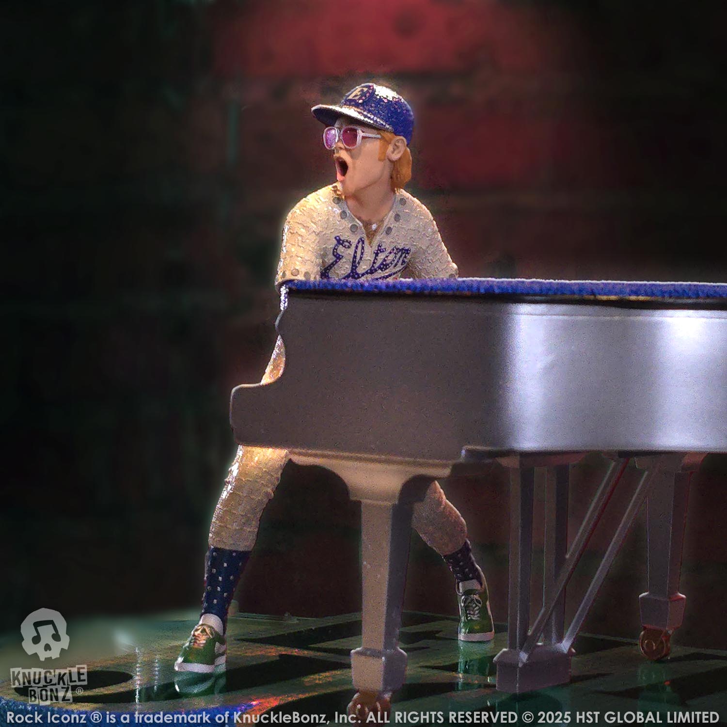 Statue of Elton John with a grand piano in a baseball uniform with a red background